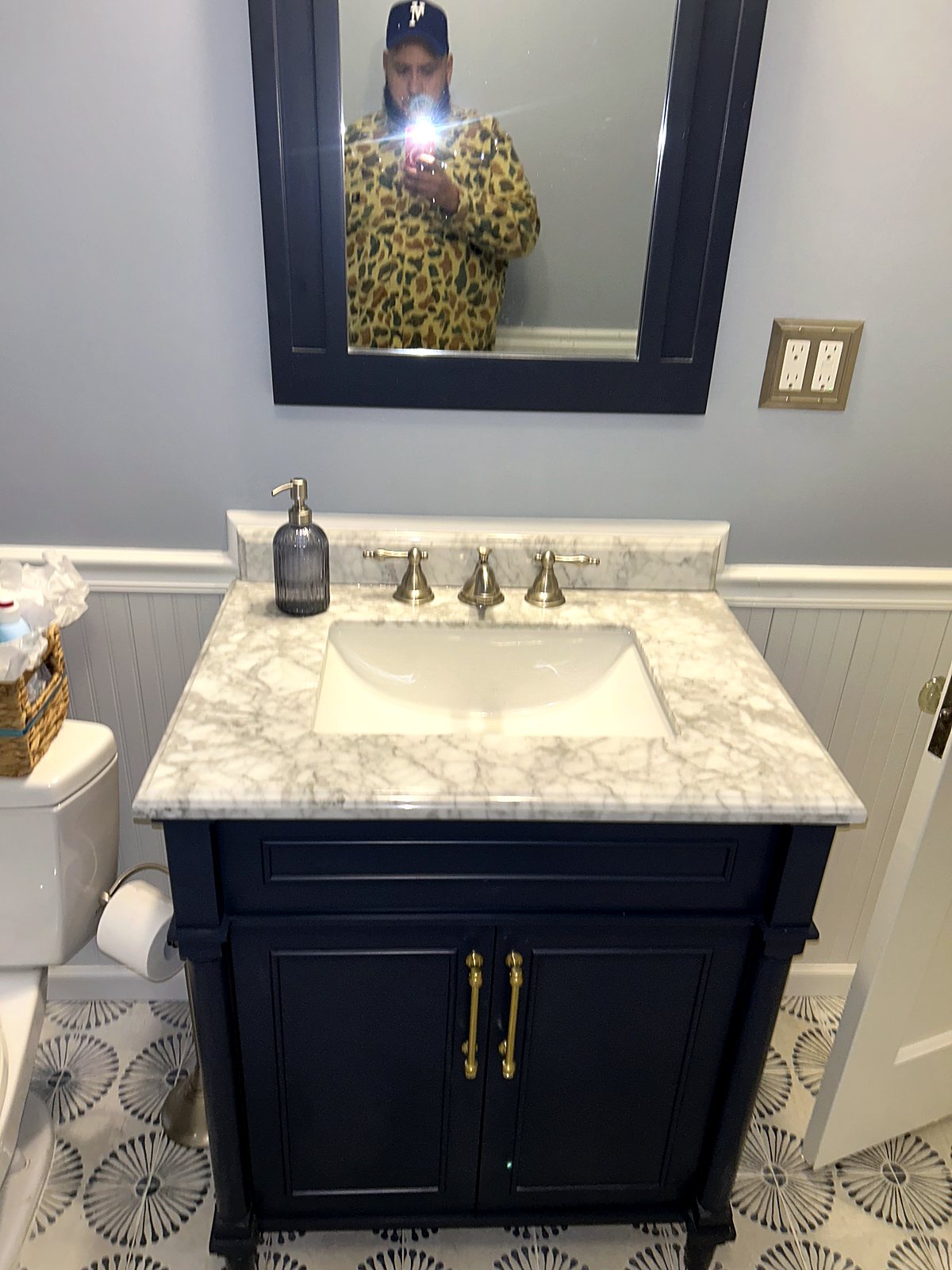 Dark navy bathroom vanity with marble countertop and brushed nickel fixtures, King County.