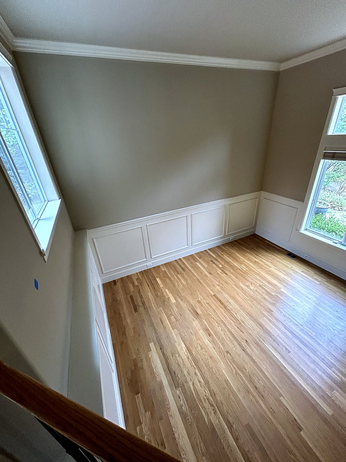 Refinished hardwood floors and wainscoting in renovated King County home.