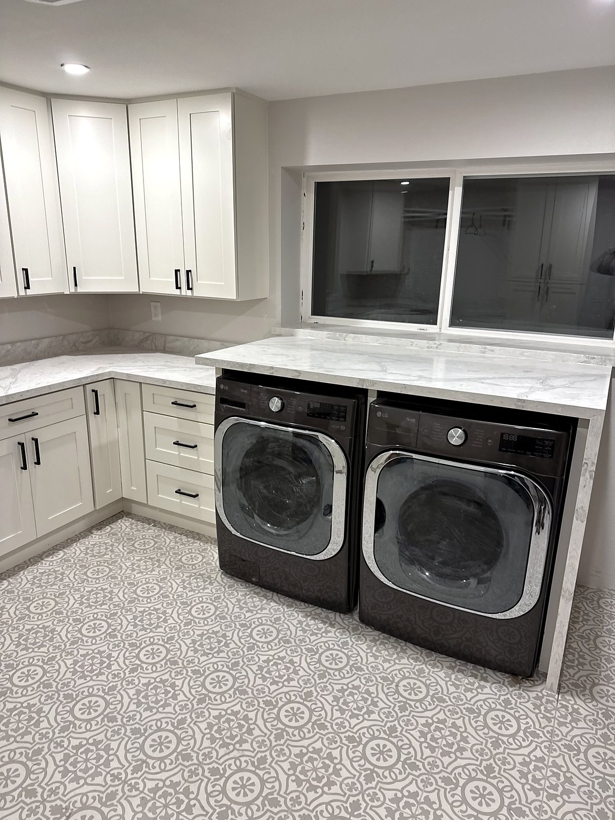 Custom laundry room with built-in washer dryer peninsula, King County renovation.