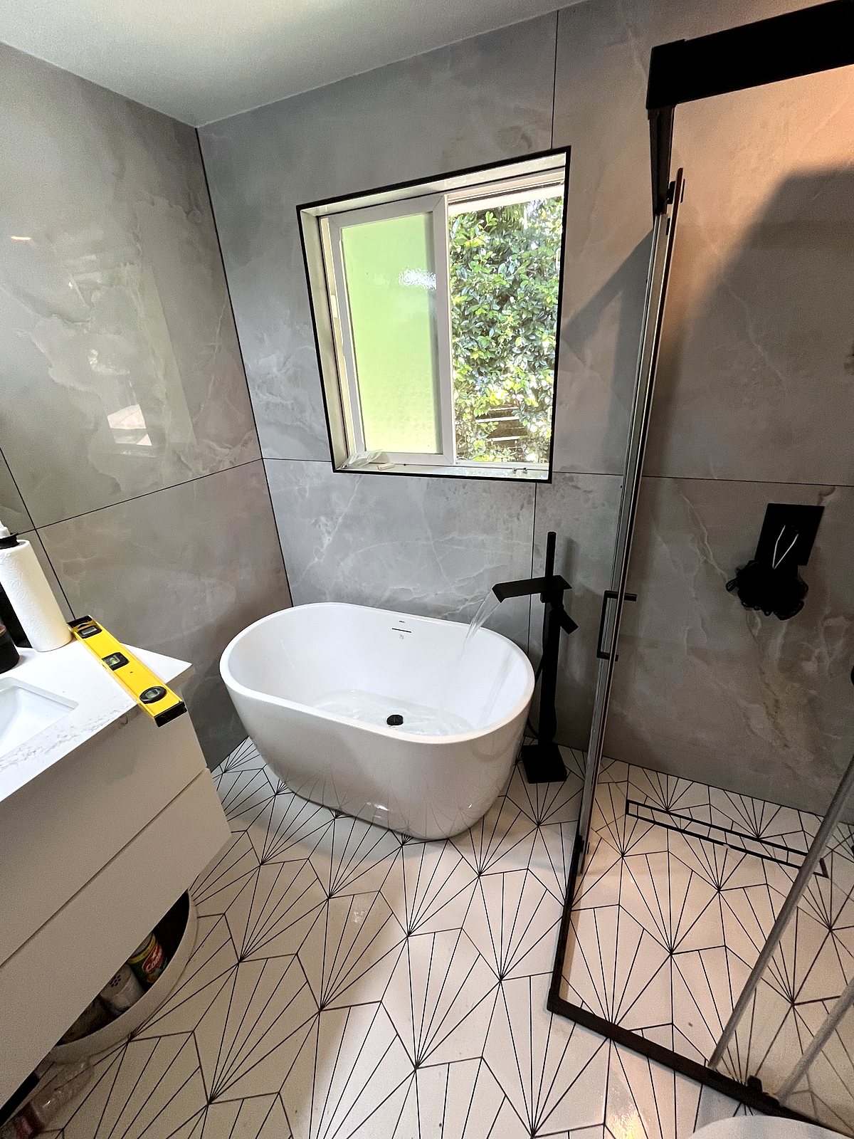 Modern bathroom renovation with freestanding tub, marble tiles, King County.