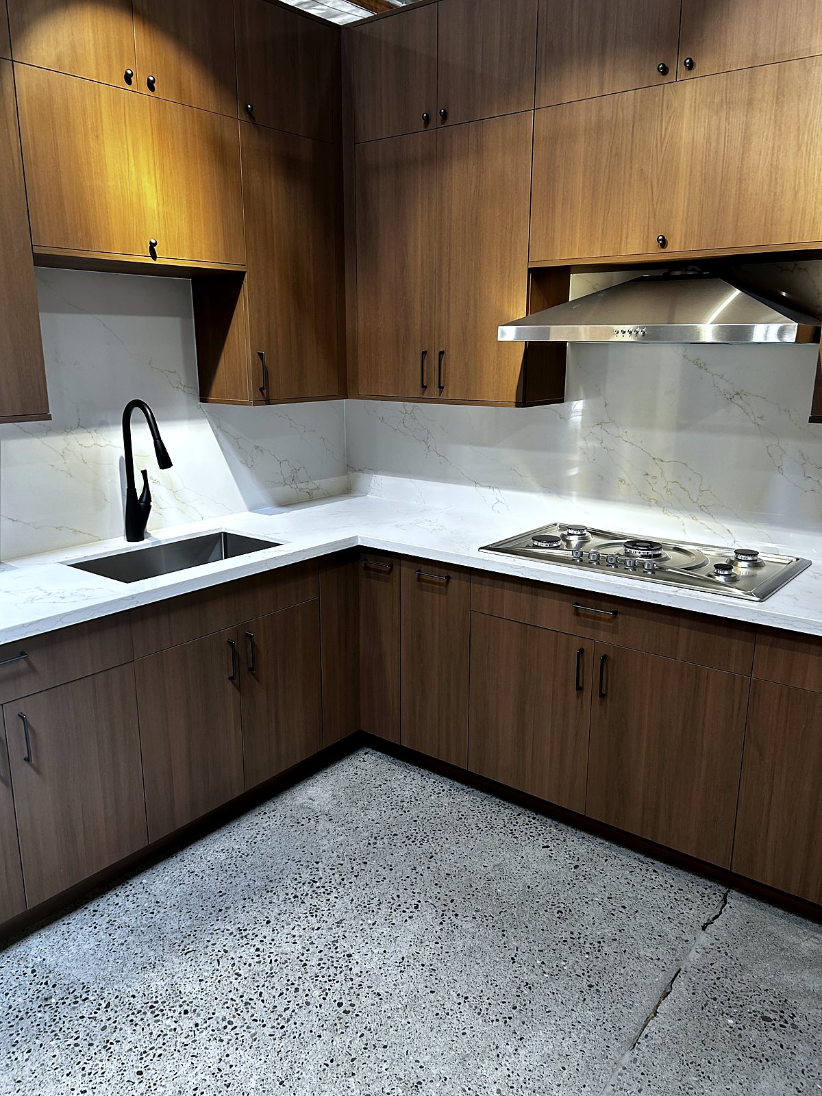 Modern kitchen renovation with wood cabinetry and quartz countertops, King County.