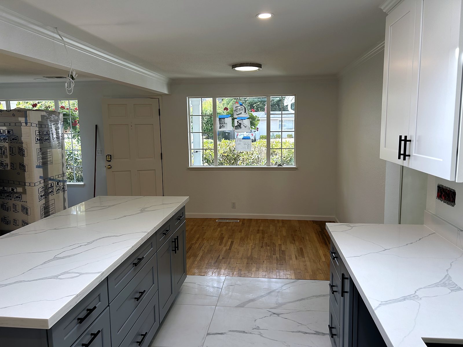 Blue-gray kitchen cabinets with quartz countertops, King County renovation.