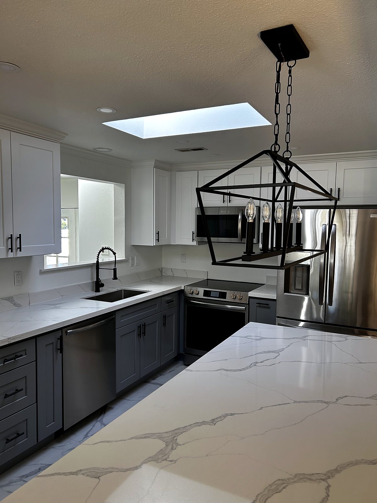 Modern two-tone kitchen remodel with quartz counters, King County.