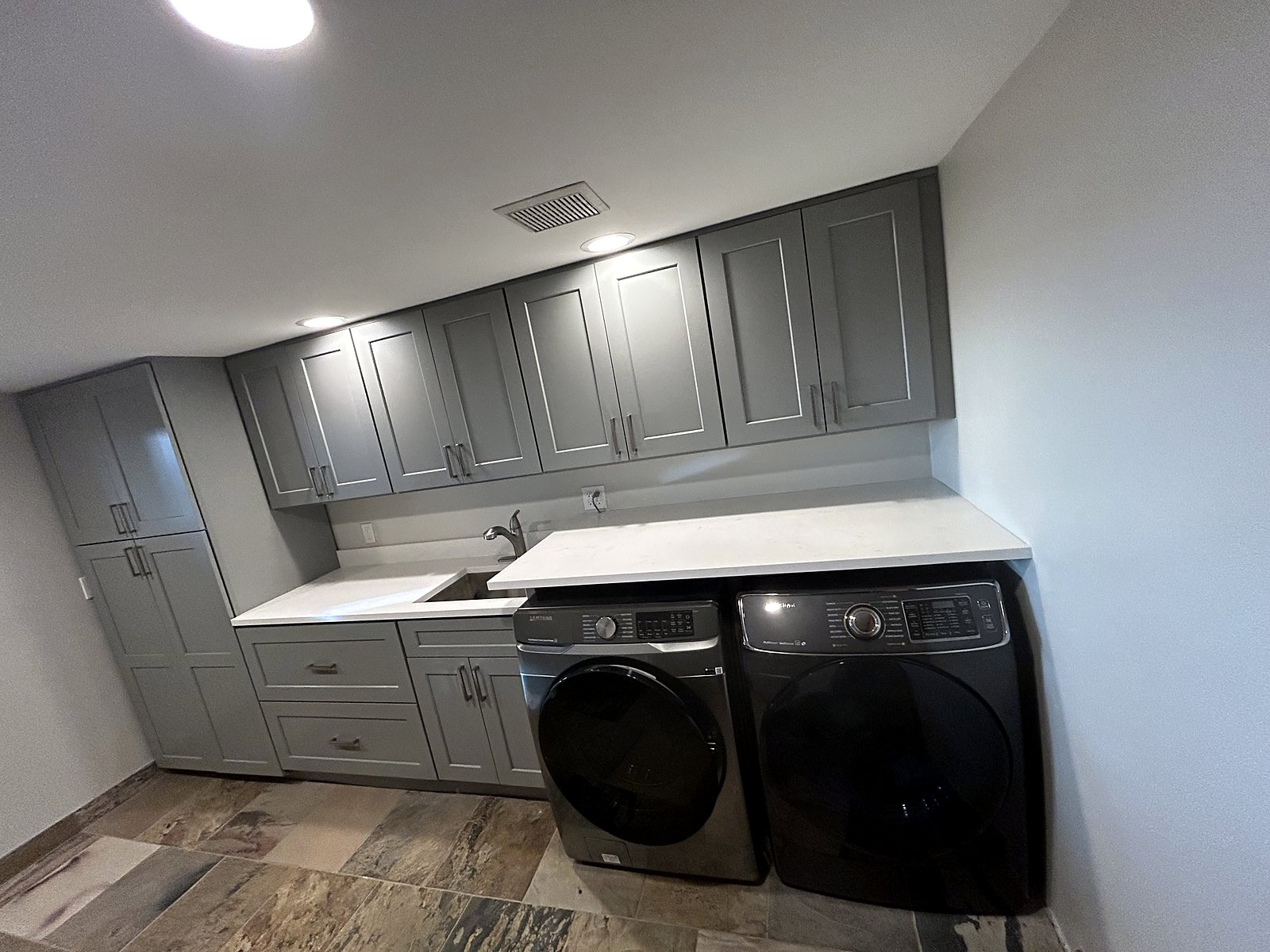 Gray shaker laundry room cabinets quartz countertop King County renovation.